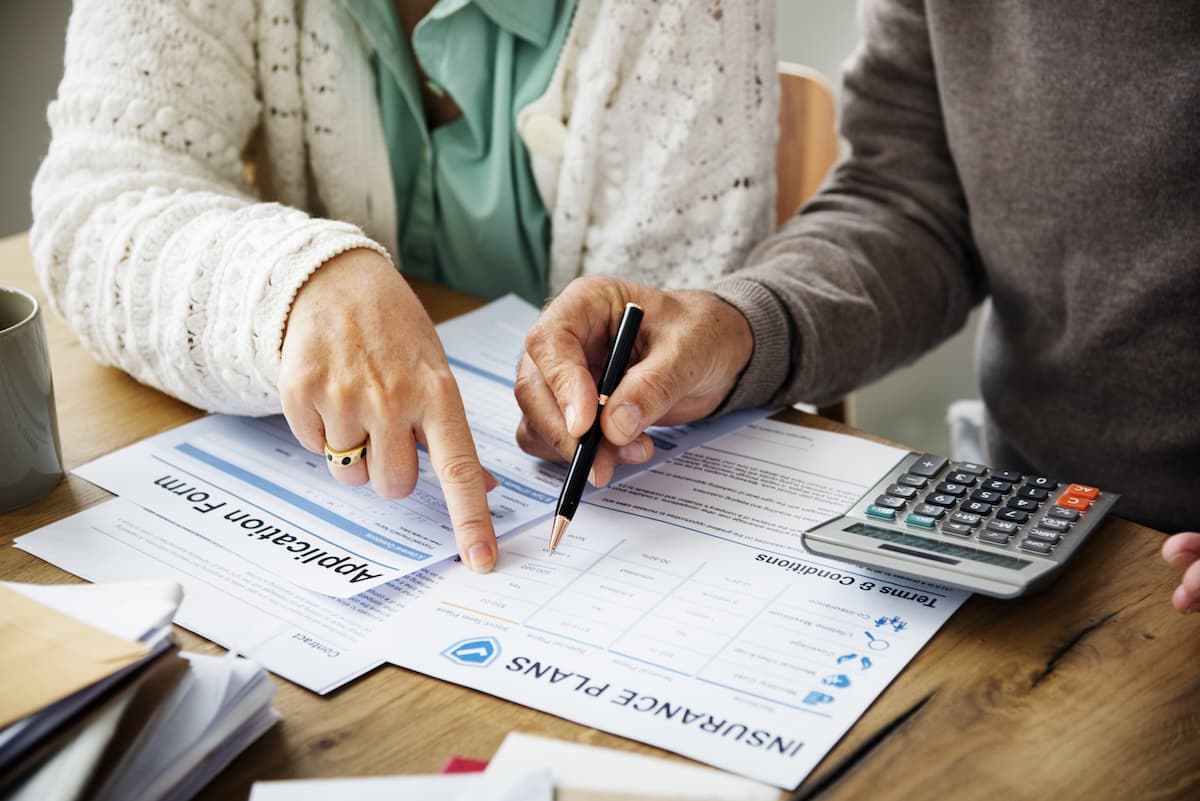 Insurance health risk assessment with forms of paper on desk