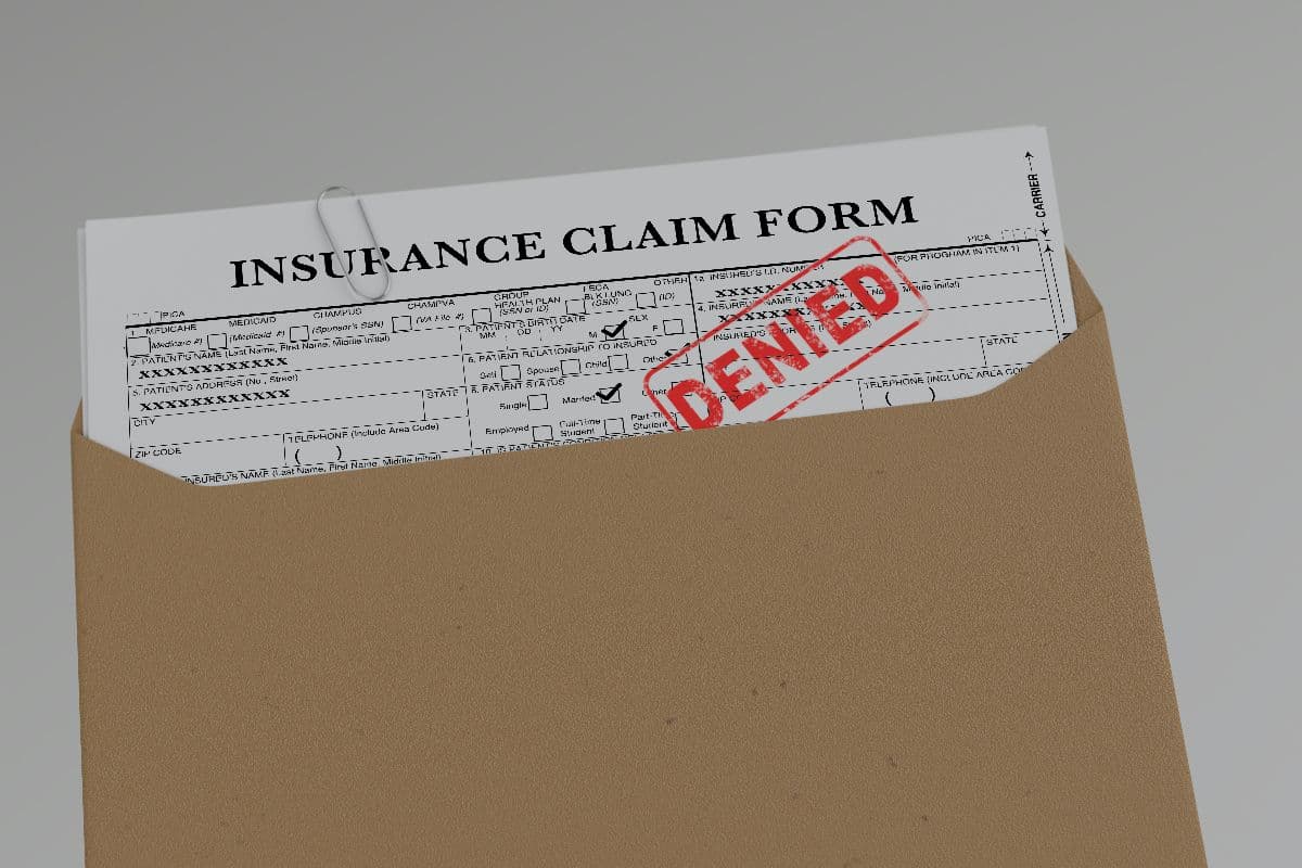 Document with denied stamp put on the wooden table