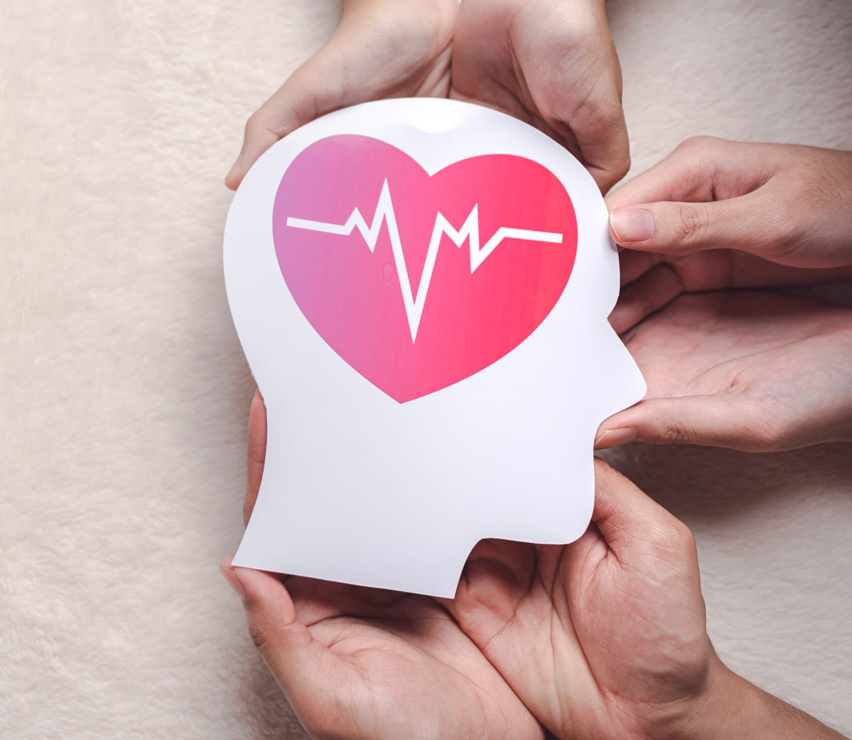 hands holding paper brain and red heart pulse, brain stroke, world heart day, world mental health day, Alzheimer and wellness concept