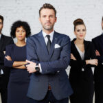 Bad faith lawyer standing in front of pack of lawyers Bad faith lawyer standing in front of pack of lawyers