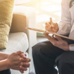 Woman patient having consultation with doctor (gynecologist or psychiatrist) and examining  health in medical gynecological clinic or hospital mental health service center