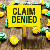 Writing note showing Claim Denied. Business photo showcasing Requested reimbursement payment for bill has been refused Clothespin holding yellow note paper crumpled papers several tries. Writing note showing Claim Denied. Business photo showcasing Requested reimbursement payment for bill has been refused Clothespin holding yellow note paper crumpled papers several tries.