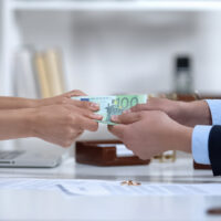 Man and woman hands pulling euro money, dividing marital property during divorce