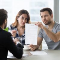 Young couple is dissatisfied with terms of contract