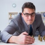 Businessman with golden coins in business growth concept Businessman with golden coins in business growth concept