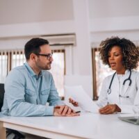 Doctor talking to a patient at medical clinic.