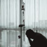 Silhouette stressful and sad Asian man sitting and worried while having medical treatment with hospital curtain and window as background. Silhouette stressful and sad Asian man sitting and worried while having medical treatment with hospital curtain and window as background.