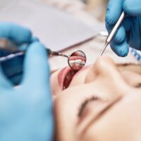 Advanced Medicine, Trusted Care. Attractive woman at the dental office. Dentist examining patient's teeth in clinic.