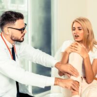 Male Doctor and Female Patient in Hospital.