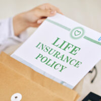 Person with contract of life insurance policy