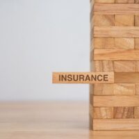 insurance written on a block of wood